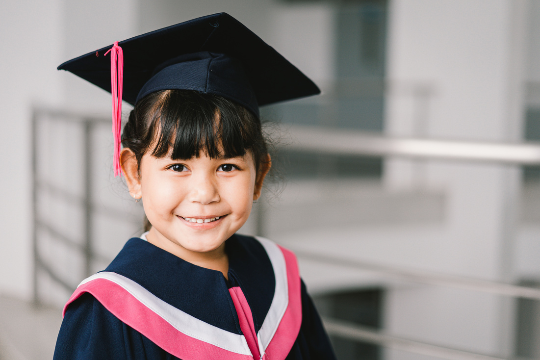 Portrait of a cute Asian graduated schoolgirl with graduatio